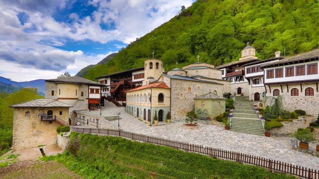 St. John the Baptist Bigorski Monastery, a historic Orthodox monastery in Mavrovo National Park, North Macedonia, built with stone buildings and surrounded by green forested mountains.